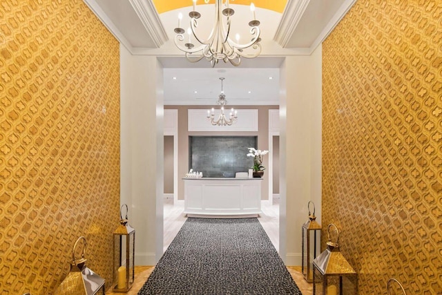 corridor with crown molding and a notable chandelier