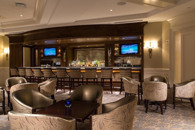 bar with a raised ceiling and ornamental molding