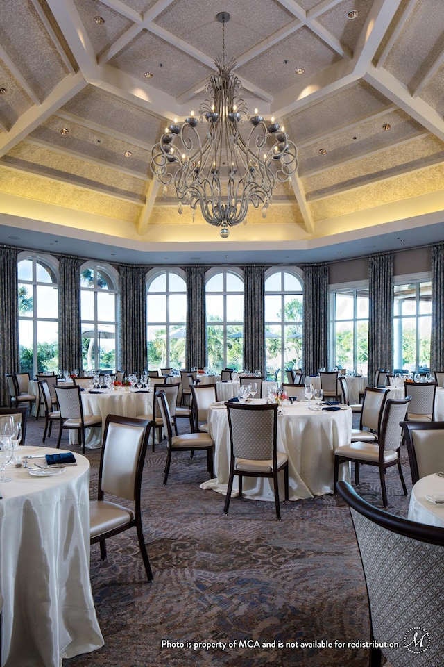 carpeted dining space with plenty of natural light, beamed ceiling, coffered ceiling, and an inviting chandelier