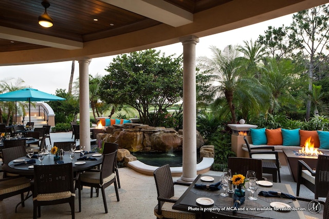 view of patio / terrace featuring an outdoor living space with a fire pit