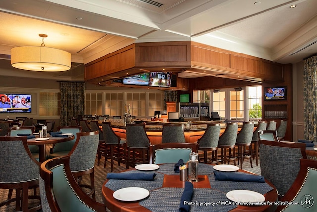 interior space with beam ceiling, coffered ceiling, and ornamental molding