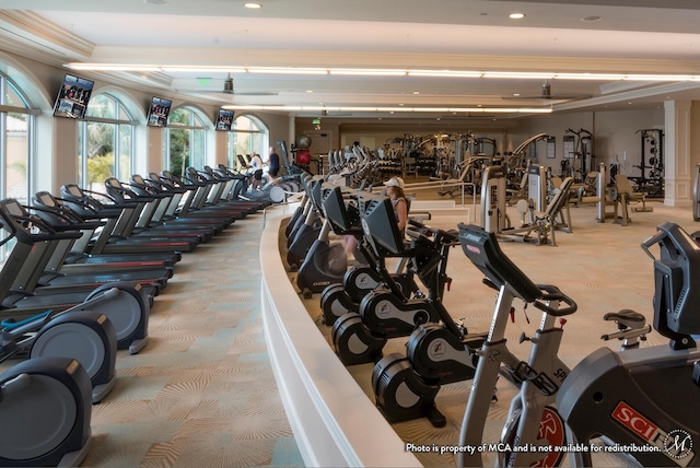 gym featuring light colored carpet and ornamental molding