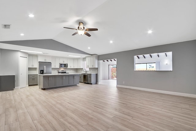 interior space with ceiling fan, light hardwood / wood-style flooring, lofted ceiling, and sink