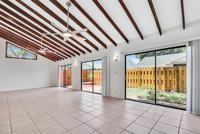 tiled empty room with high vaulted ceiling, ceiling fan, a wealth of natural light, and beam ceiling