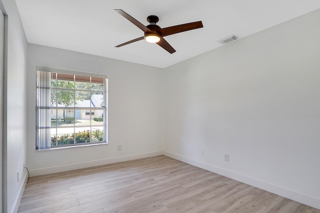 spare room with light wood-type flooring and ceiling fan