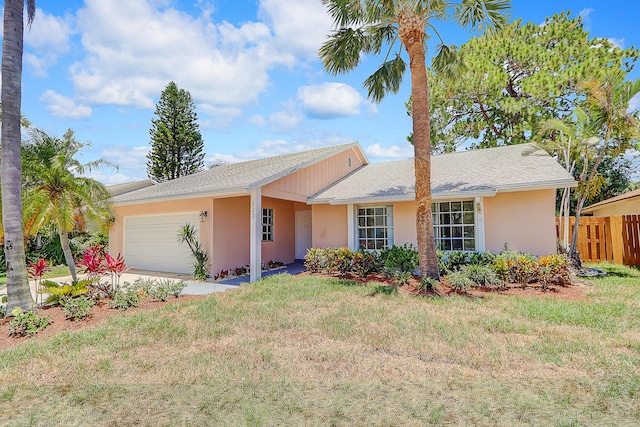 single story home with a front yard and a garage