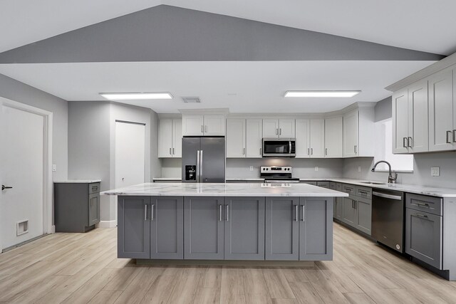 interior space featuring vaulted ceiling, ceiling fan, and light hardwood / wood-style flooring