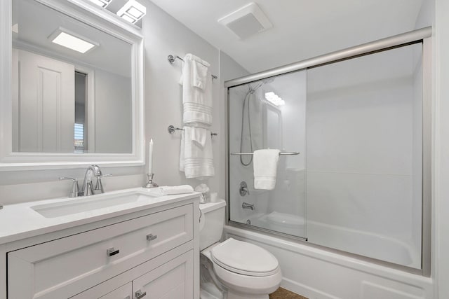 full bathroom with shower / bath combination with glass door, vanity, and toilet