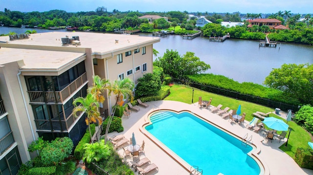 view of swimming pool featuring a patio area and a water view