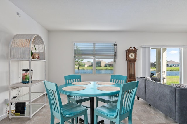 dining room featuring a wealth of natural light and a water view