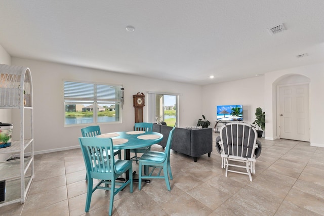 dining space featuring light tile patterned floors