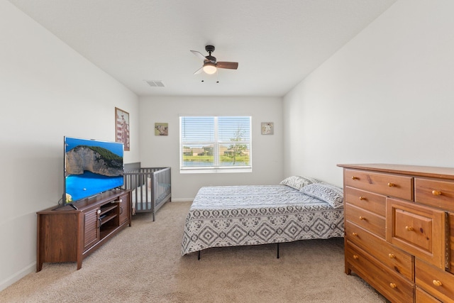 bedroom featuring light carpet and ceiling fan