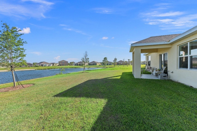 view of yard featuring a patio and a water view