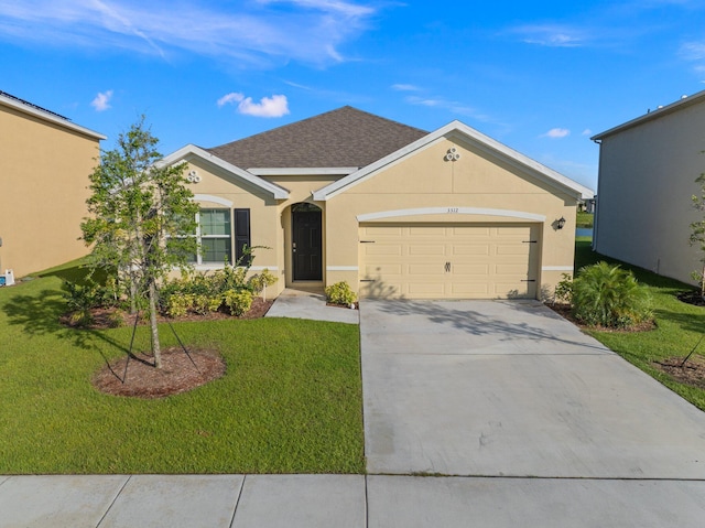 ranch-style house featuring a front yard and a garage