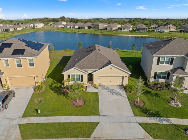 birds eye view of property with a water view