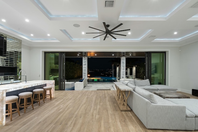 living room with ceiling fan, light hardwood / wood-style floors, and ornamental molding