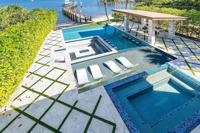 view of pool featuring a boat dock, a water view, and ceiling fan