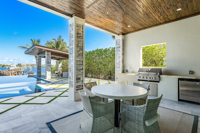 view of patio with ceiling fan and a water view