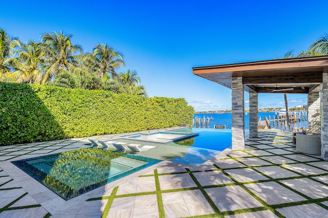 view of swimming pool featuring an in ground hot tub, a water view, and central AC unit