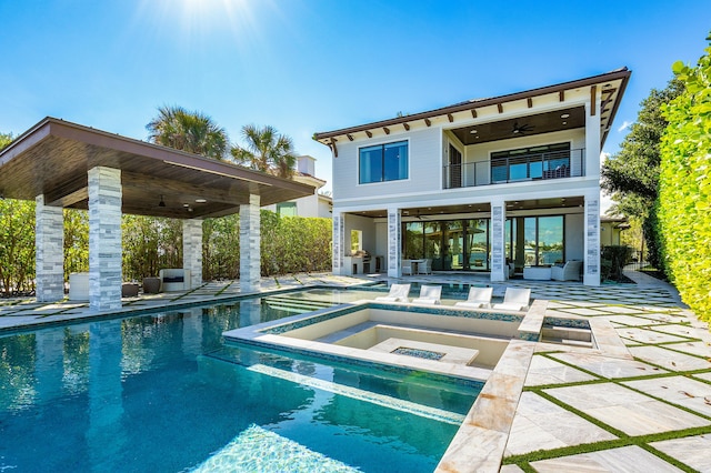 view of swimming pool with a patio, ceiling fan, and a lawn