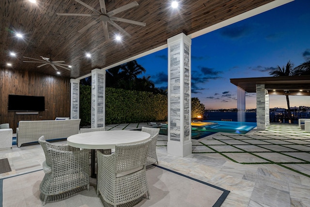 pool at dusk with an in ground hot tub, a gazebo, and a patio