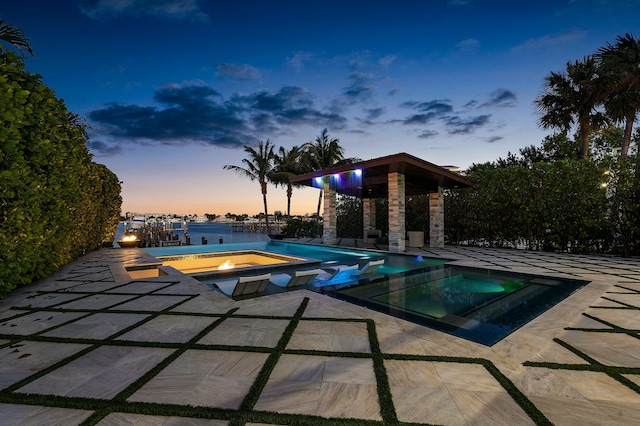 pool at dusk with a water view