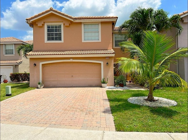 mediterranean / spanish-style home featuring a garage and a front lawn