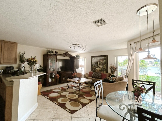 living room featuring light tile flooring and a textured ceiling