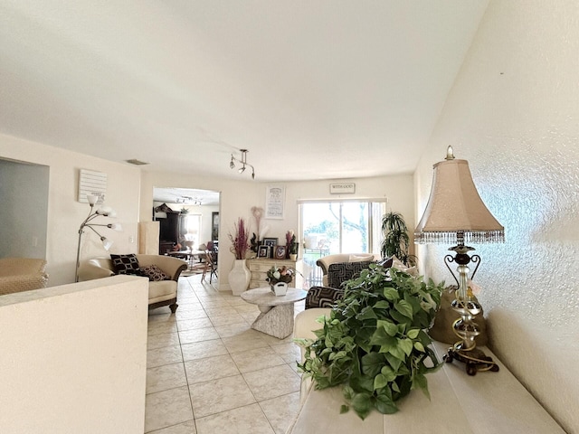 living room featuring light tile floors and rail lighting