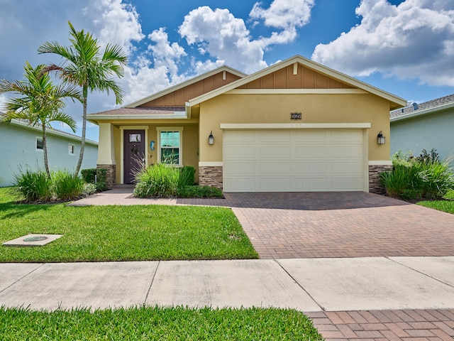 view of front of property with a front yard and a garage