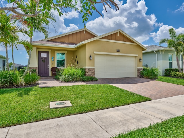 view of front of property with a front yard and a garage