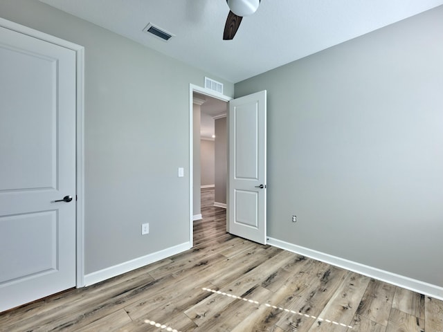 unfurnished bedroom with ceiling fan and light wood-type flooring