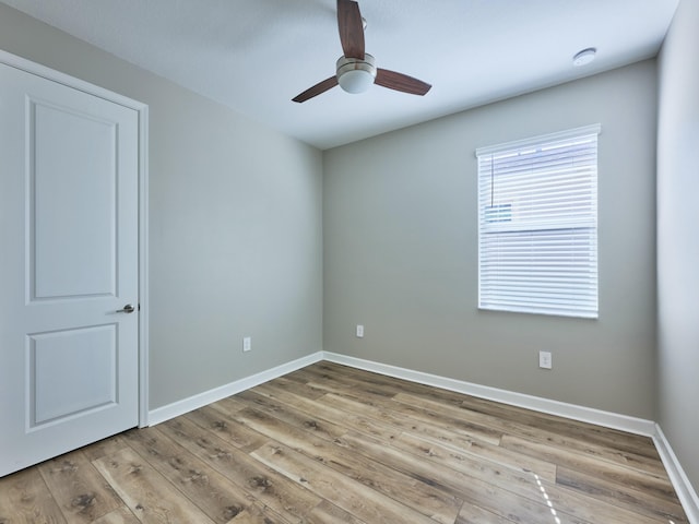 unfurnished room featuring light wood-type flooring and ceiling fan