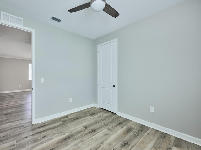 spare room with ceiling fan and light hardwood / wood-style floors