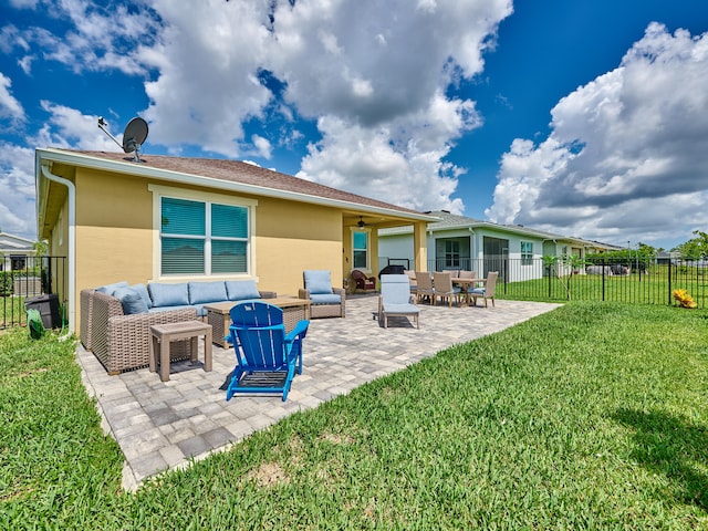 rear view of property with a lawn, a patio, and an outdoor hangout area