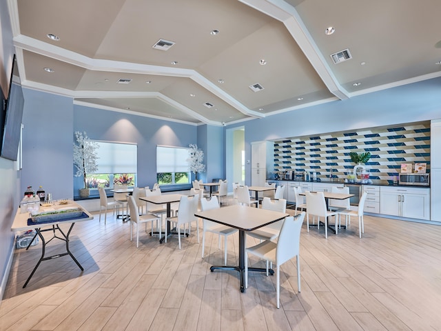 dining room featuring light wood-type flooring and lofted ceiling