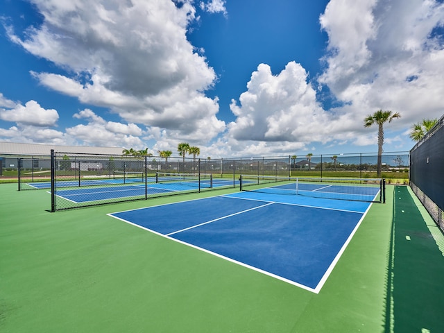 view of tennis court with basketball hoop