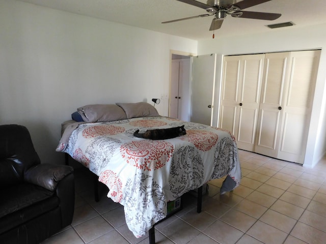 tiled bedroom featuring a closet and ceiling fan