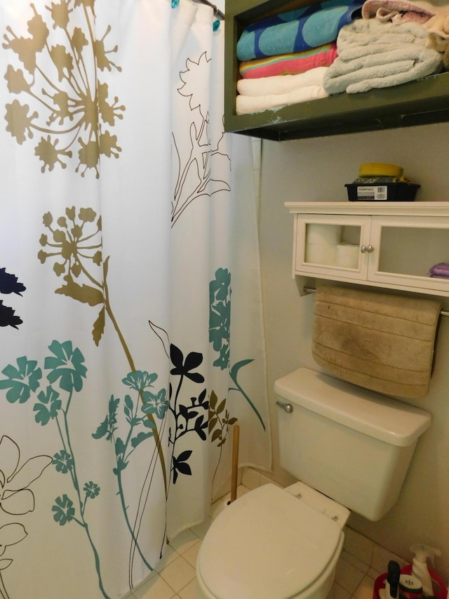 bathroom with tile flooring and toilet