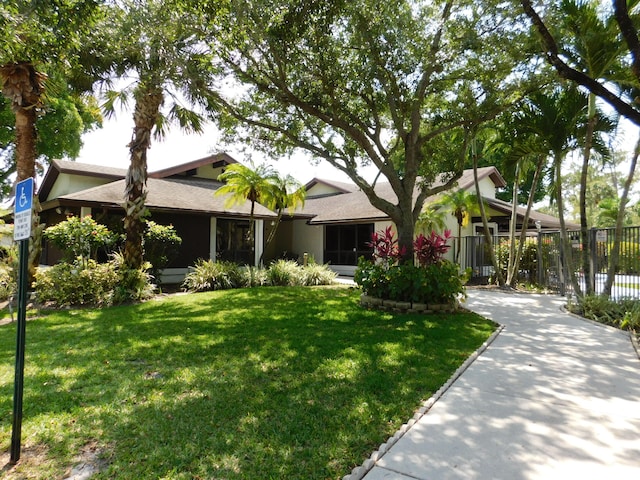 single story home featuring a front yard