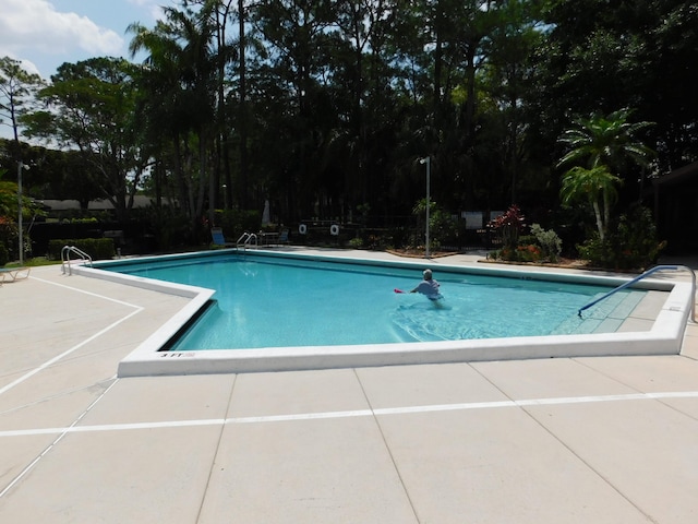 view of swimming pool with a patio area