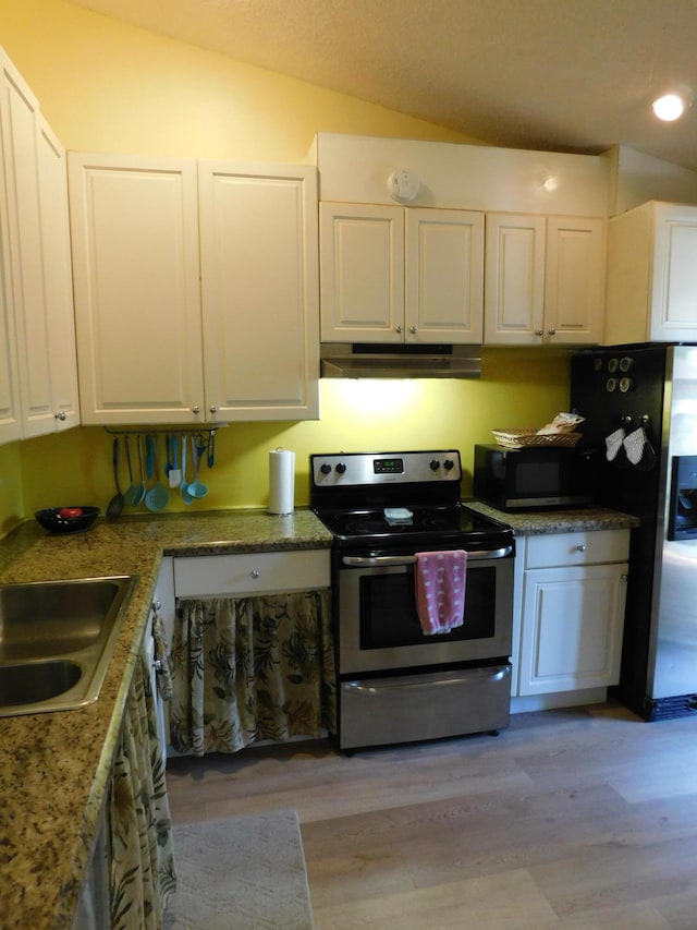 kitchen with stainless steel appliances, light hardwood / wood-style flooring, lofted ceiling, and white cabinetry