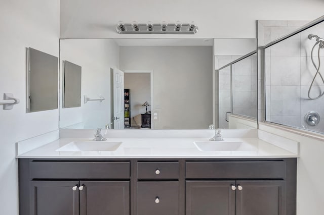 bathroom featuring vanity and an enclosed shower