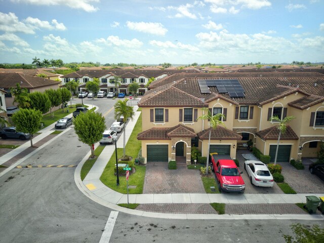 view of front of home featuring a garage and solar panels