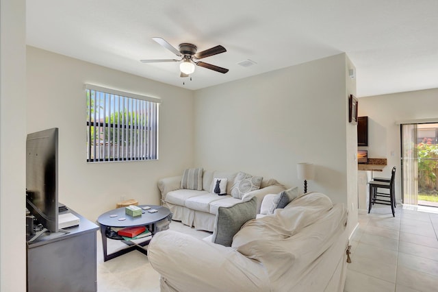 tiled living room featuring ceiling fan