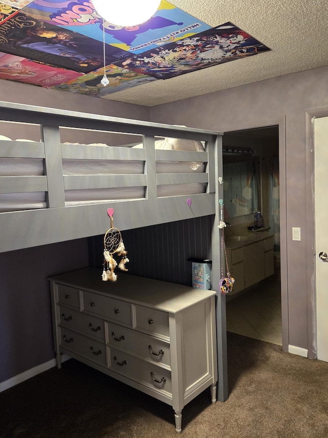 carpeted bedroom with sink and a textured ceiling