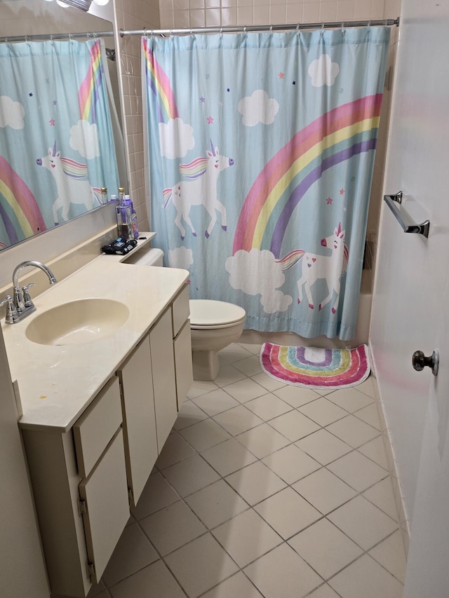 full bathroom featuring vanity, toilet, tile patterned floors, and shower / tub combo with curtain