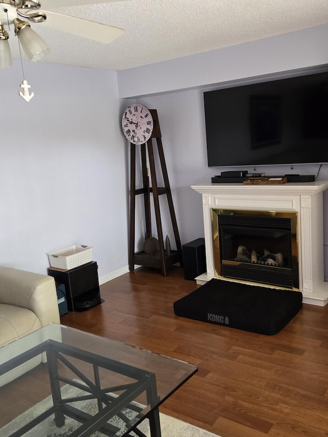 living room featuring a textured ceiling and dark hardwood / wood-style flooring