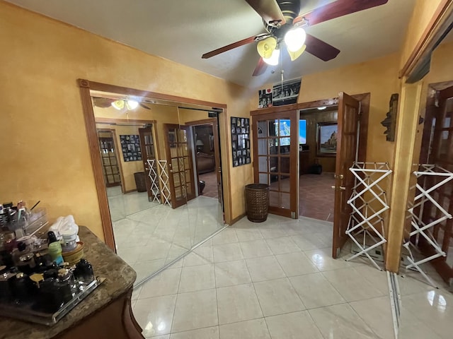 interior space with french doors, light tile patterned floors, and lofted ceiling