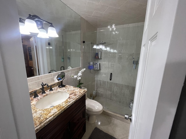 bathroom with vanity, backsplash, tile patterned flooring, toilet, and an enclosed shower